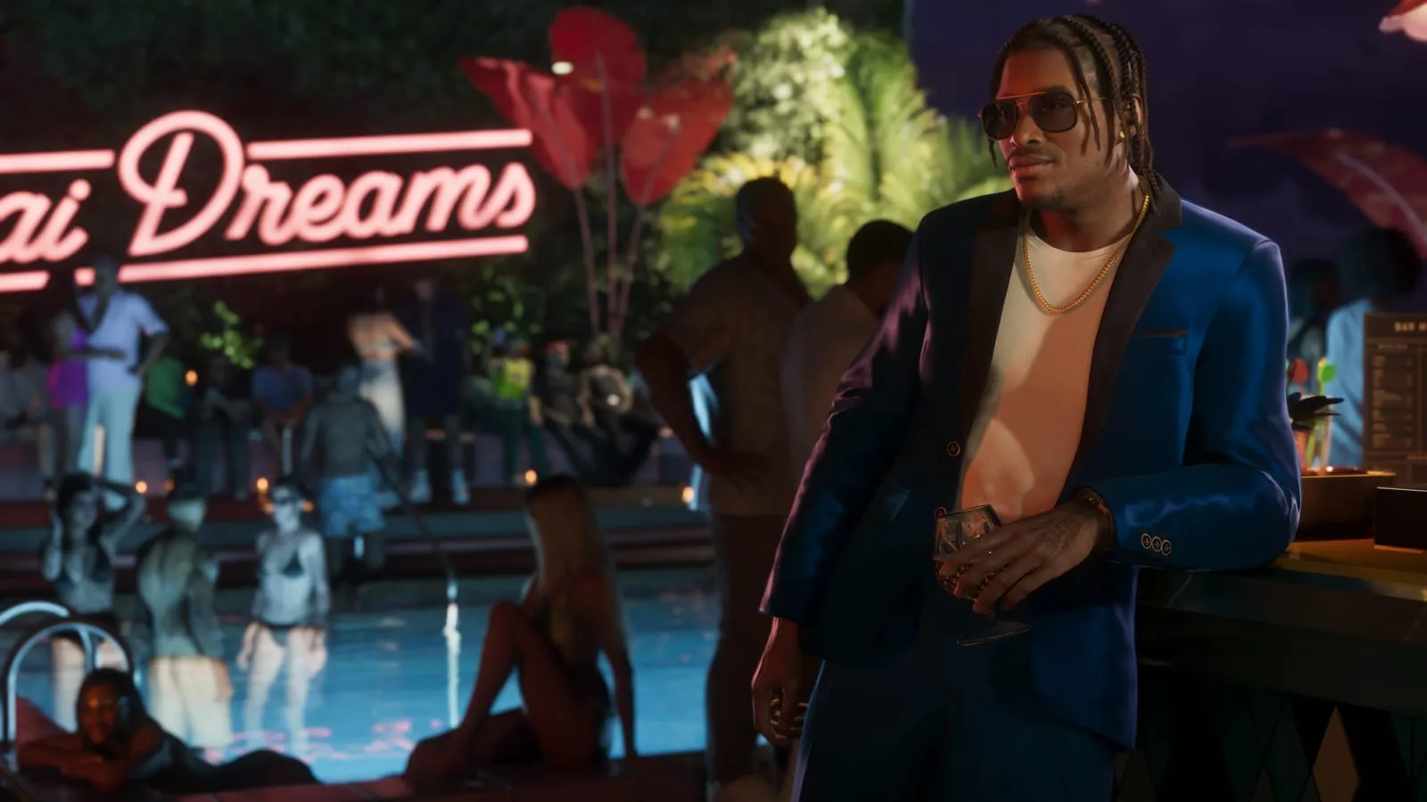 Braided man leaning on a poolside bar at night, pink neon Dreams sign glowing behind him