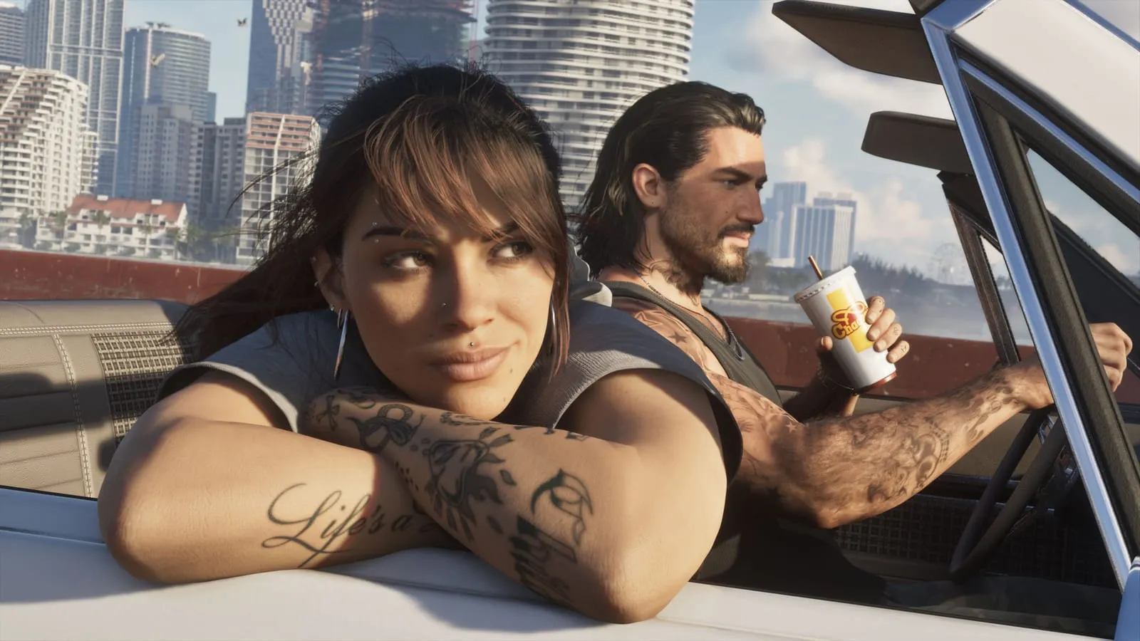 Lucia and Jason in a convertible in front of the Vice City towers