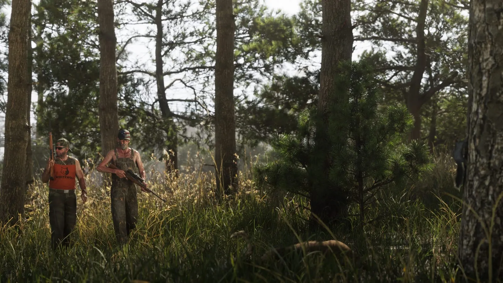 Two armed hunters wading through tall grass in a pine forest, a deer bedded down nearby