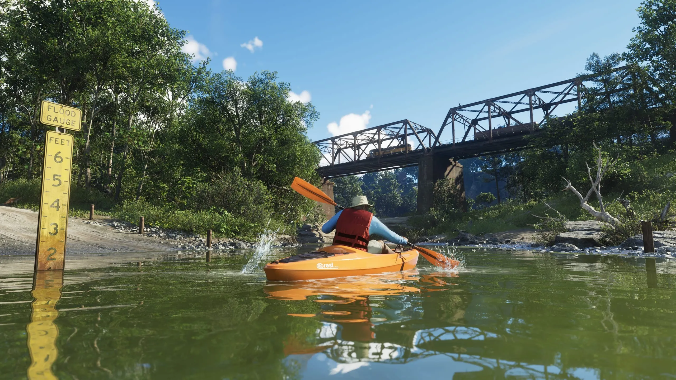 Kayaker paddling a green river past a flood gauge, freight bridge crossing behind