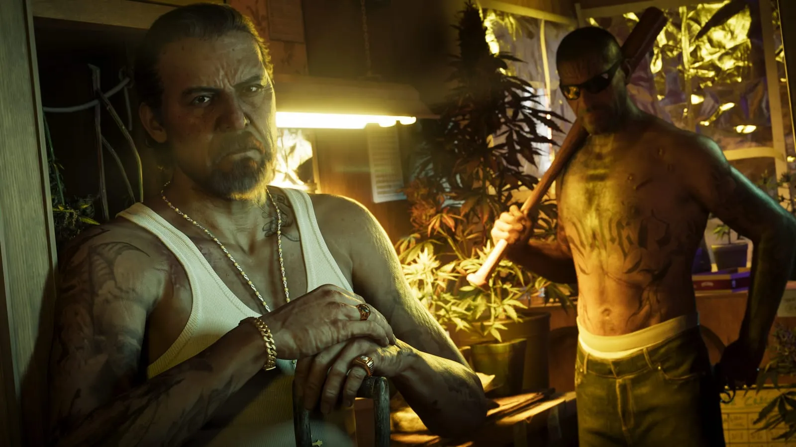 Two tattooed men stand inside a lamp-lit cannabis grow room, one holding a baseball bat over his shoulder