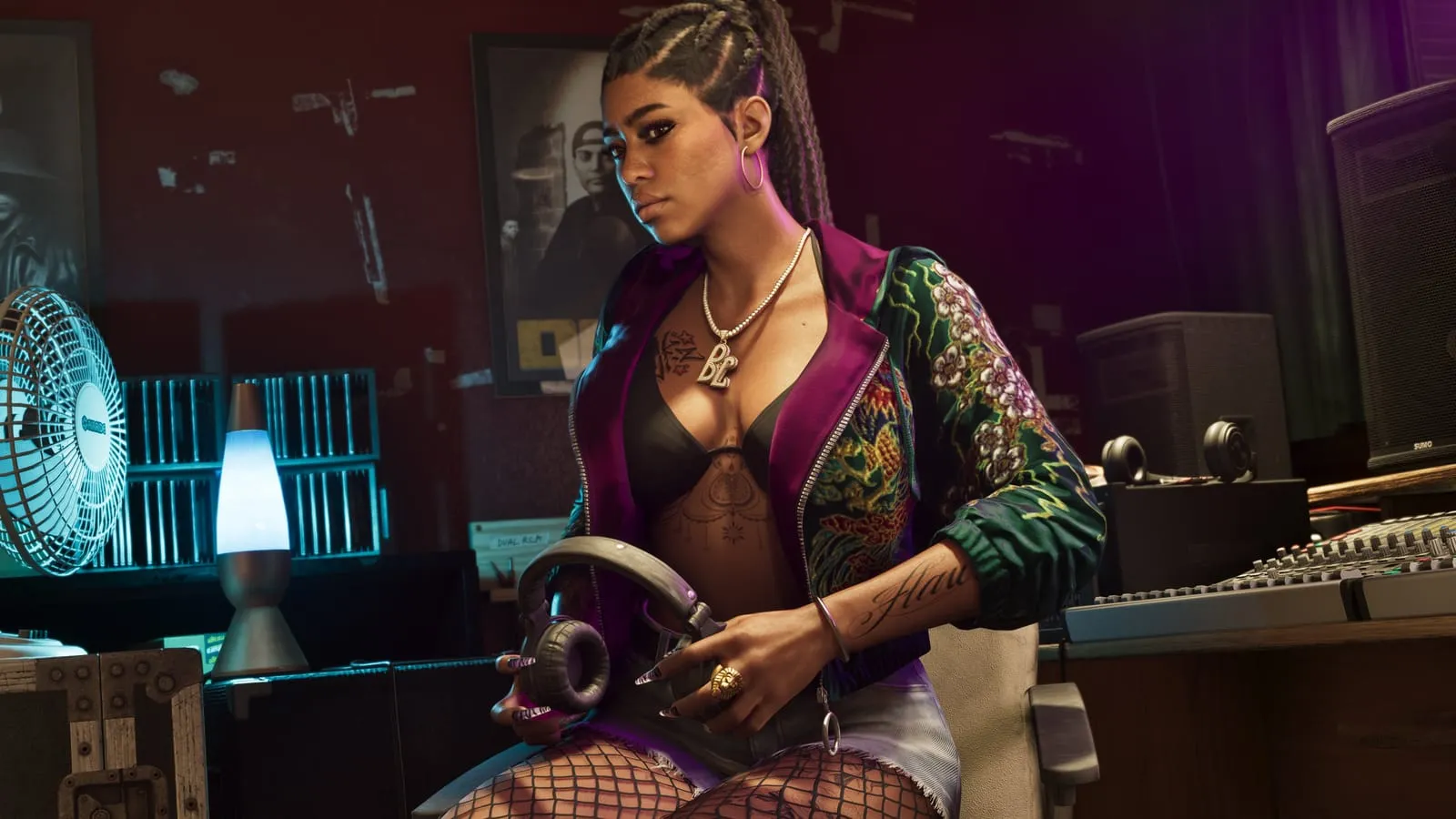 Young woman in an embroidered bomber holds studio headphones in a recording booth