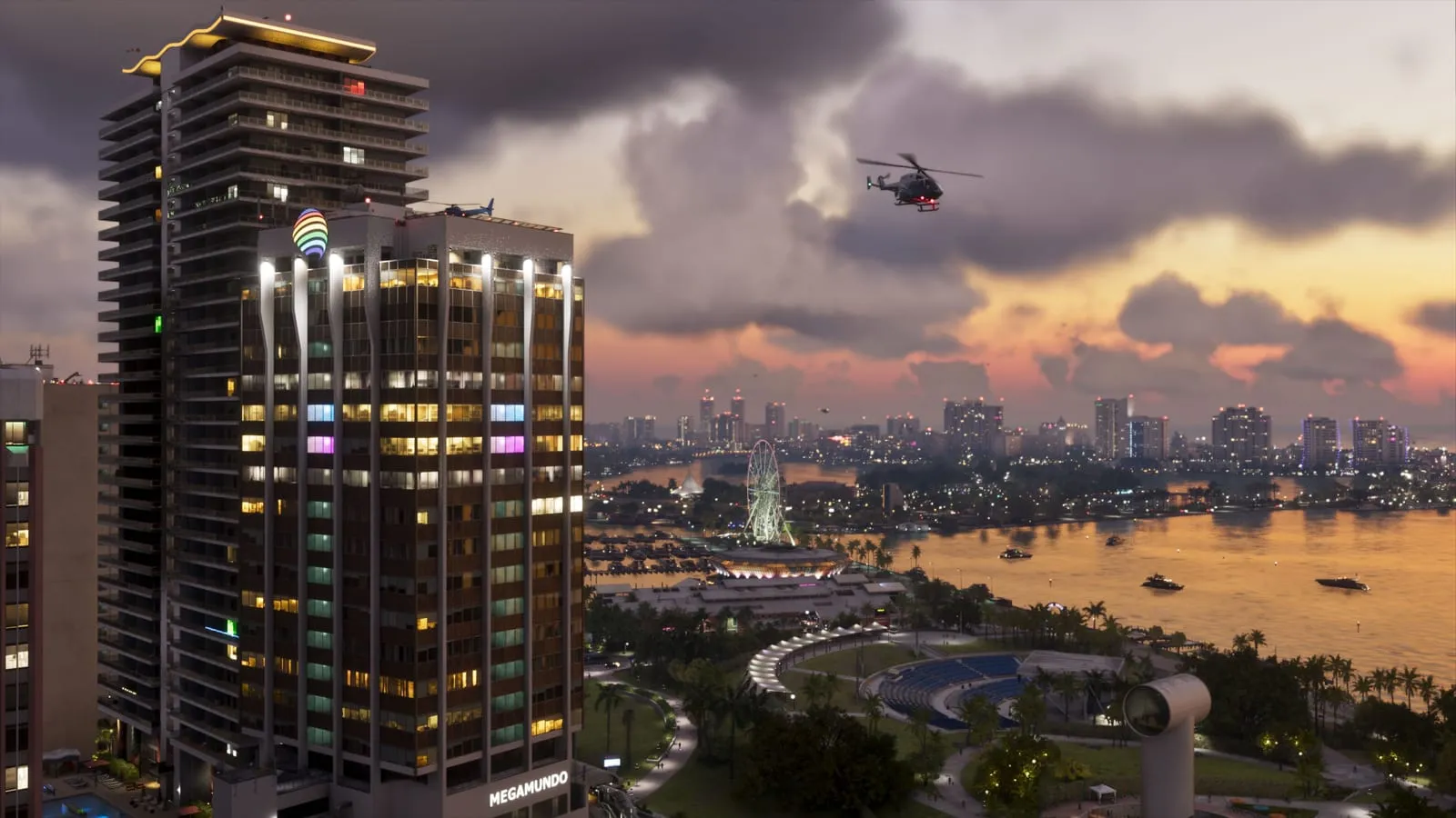 A helicopter flies over Vice City bay at dusk, past the Ferris wheel and lit towers